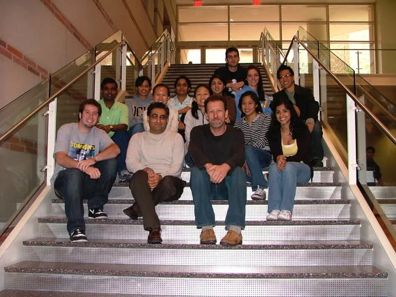 Bitan Lab student researchers sit on a staircase with Dr. Bitan.