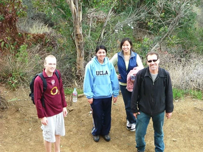 Dr. Bitan and three students take a break during an outdoor team hike.