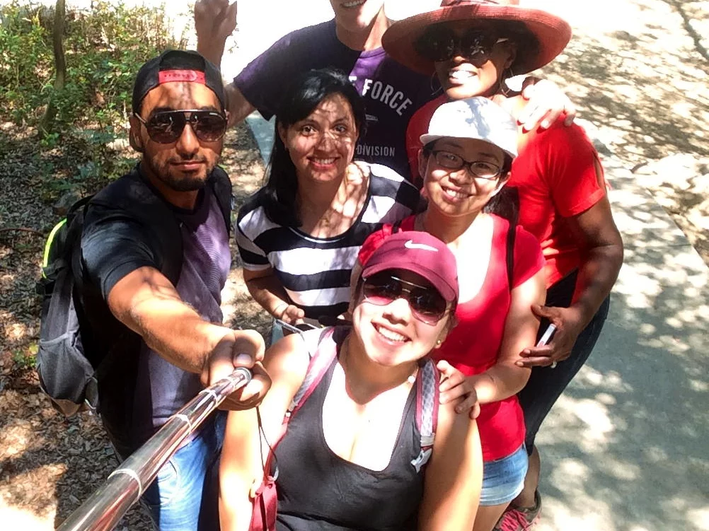 Lab members, a hiking trail, and a selfie-stick. Students stop to pose for a photo during a lab outing.
