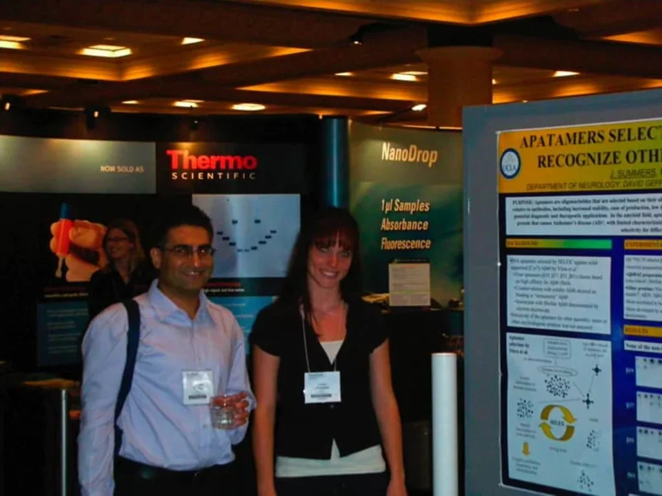 Two students stand in front of science fair displays.
