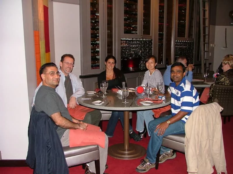 Dr. Bitan and four members of his research team sit at a table for dinner.