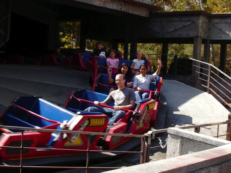 Lab members ride a small roller coaster during a team outing.