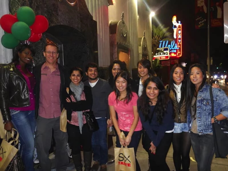 The Bitan Lab team stands on a city sidewalk after having dinner together.
